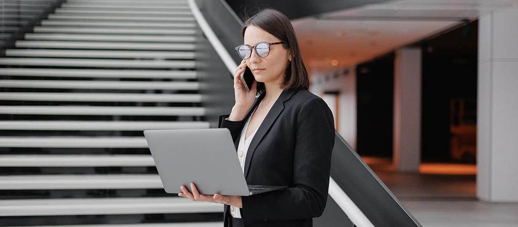 woman working with a laptop and on the phone A new skillset for accounts payable professionals